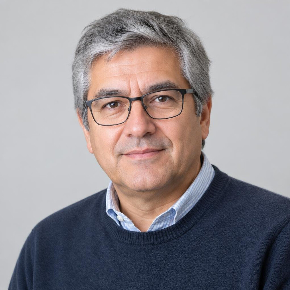 Studio portrait of an older Chilean man with glasses